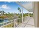 Spacious covered balcony with white railings and tropical landscaping views, great for relaxation at 614 Norton St, Longboat Key, FL 34228