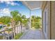 Relaxing balcony with palm tree views and a white railing, perfect for outdoor enjoyment at 614 Norton St, Longboat Key, FL 34228