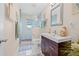 Bright bathroom featuring a glass walk-in shower, white tile floors, and a dark wood vanity at 614 Norton St, Longboat Key, FL 34228