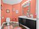 Unique bathroom with coral walls, modern vanity, decorative flamingos, and updated fixtures at 614 Norton St, Longboat Key, FL 34228