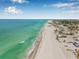 Breathtaking aerial view of the coastline, highlighting the stunning white sandy beach and crystal-clear turquoise waters at 614 Norton St, Longboat Key, FL 34228