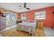 Inviting bedroom with a floral-patterned comforter, vibrant walls, and plenty of natural light at 614 Norton St, Longboat Key, FL 34228