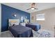 Cozy bedroom with a blue accent wall, twin beds, and beach-themed decor at 614 Norton St, Longboat Key, FL 34228
