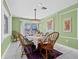 Elegant dining room with stylish chandelier, table set for dinner, and ample natural light at 614 Norton St, Longboat Key, FL 34228