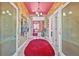 Hallway with bright pinks and reds and ornate doorways at 614 Norton St, Longboat Key, FL 34228