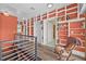 Bright hallway with a wall of built-in bookshelves and modern railings leading to the staircase at 614 Norton St, Longboat Key, FL 34228