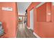 Bright hallway with hardwood floors, featuring staircase, mirror, and white doors at 614 Norton St, Longboat Key, FL 34228