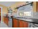 Kitchen sink with stainless steel appliances, dark countertops, and wood cabinets at 614 Norton St, Longboat Key, FL 34228