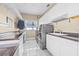 Well-equipped laundry room with modern washer and dryer, counter space, and storage cabinets at 614 Norton St, Longboat Key, FL 34228