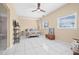 Bright main bedroom with tile flooring, natural light, a ceiling fan, and ensuite bathroom access at 614 Norton St, Longboat Key, FL 34228