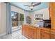 Bright office featuring a large wooden desk, tiled floors, a ceiling fan and a balcony with canal views at 614 Norton St, Longboat Key, FL 34228