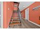 Hallway staircase with wood treads, metal railing, and wood flooring at 614 Norton St, Longboat Key, FL 34228