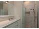 Stylish bathroom featuring marble-look tile shower with pebble floor and frameless glass at 632 S Florida Ave, Tarpon Springs, FL 34689