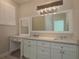 Elegant bathroom with double sink vanity, marble countertop, and modern lighting fixtures at 632 S Florida Ave, Tarpon Springs, FL 34689