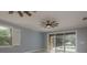 Relaxing bedroom featuring stylish ceiling fans, wood-look floors, and sliding glass doors at 632 S Florida Ave, Tarpon Springs, FL 34689