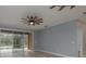 Bright bedroom with ceiling fans and sliders opening up to a screened patio with pool views at 632 S Florida Ave, Tarpon Springs, FL 34689