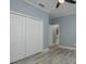 Bedroom featuring a double closet with wood-look flooring at 632 S Florida Ave, Tarpon Springs, FL 34689