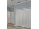 Neat bedroom with a double folding door closet and modern light-colored laminate floors at 632 S Florida Ave, Tarpon Springs, FL 34689