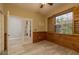 Unique bedroom with wood-paneled accent wall and modern shutters, creating a warm and inviting space at 632 S Florida Ave, Tarpon Springs, FL 34689