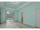 Spacious primary bedroom with light blue walls, and sliding doors opening up to the pool at 632 S Florida Ave, Tarpon Springs, FL 34689