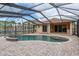 Wonderful backyard view of an in-ground pool with screened enclosure and brick patio at 632 S Florida Ave, Tarpon Springs, FL 34689