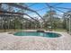 Sparkling in-ground pool is surrounded by a screened enclosure and brick patio at 632 S Florida Ave, Tarpon Springs, FL 34689