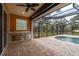 Inviting outdoor pool area with screened enclosure and outdoor kitchen at 632 S Florida Ave, Tarpon Springs, FL 34689