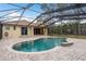 Inviting in-ground pool with brick patio and screened enclosure at 632 S Florida Ave, Tarpon Springs, FL 34689