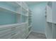 Spacious walk-in closet with custom shelves and drawers, perfect for organization at 632 S Florida Ave, Tarpon Springs, FL 34689