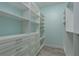 Well-organized walk-in closet with custom shelving and drawers, providing ample storage space at 632 S Florida Ave, Tarpon Springs, FL 34689