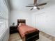 Bright bedroom with a ceiling fan, natural light, and closet storage at 6521 Cedarbrook S Dr, Pinellas Park, FL 33782