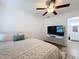 Bright bedroom with ceiling fan, ensuite bathroom, and modern decor at 6521 Cedarbrook S Dr, Pinellas Park, FL 33782