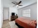 This bedroom features a ceiling fan, a modern dresser, and a bright window at 6521 Cedarbrook S Dr, Pinellas Park, FL 33782