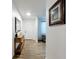 Bright foyer with wood floors, a decorative mirror, and views to other rooms at 6521 Cedarbrook S Dr, Pinellas Park, FL 33782