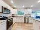 This bright kitchen features stainless steel appliances, a stylish countertop, and ample natural light at 6521 Cedarbrook S Dr, Pinellas Park, FL 33782