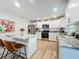 Bright kitchen boasts granite countertops, stainless steel appliances, and a breakfast bar with seating at 6521 Cedarbrook S Dr, Pinellas Park, FL 33782