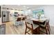 Open kitchen featuring white cabinets, an island with seating, and stainless steel appliances at 6521 Cedarbrook S Dr, Pinellas Park, FL 33782