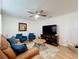 Comfortable living room with wood floors, plush seating, and a large entertainment center at 6521 Cedarbrook S Dr, Pinellas Park, FL 33782