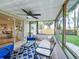Screened patio includes seating, ceiling fan, and backyard views at 6521 Cedarbrook S Dr, Pinellas Park, FL 33782