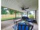 Screened in patio with tile floors, furniture, and backyard access at 6521 Cedarbrook S Dr, Pinellas Park, FL 33782
