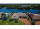Expansive aerial view of the home showcasing waterfront access, lush landscaping, and a private pool at 671 Tallahassee Ne Dr, St Petersburg, FL 33702