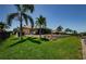 Spacious backyard with lush green grass and clear view of the home's lanai at 671 Tallahassee Ne Dr, St Petersburg, FL 33702