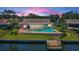 Aerial view of the pool and deck area with lush lawns and a waterfront dock at 671 Tallahassee Ne Dr, St Petersburg, FL 33702
