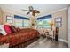 Comfortable bedroom with a decorative ceiling fan, two windows, and a writing desk at 671 Tallahassee Ne Dr, St Petersburg, FL 33702