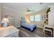 Cozy bedroom featuring a ceiling fan, window and light-colored furniture at 671 Tallahassee Ne Dr, St Petersburg, FL 33702