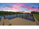 Scenic waterfront view from a wooden dock at sunset with colorful sky, offering a tranquil escape at 671 Tallahassee Ne Dr, St Petersburg, FL 33702