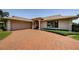 A beautiful exterior view shows a well-maintained home featuring a two-car garage and manicured landscaping at 671 Tallahassee Ne Dr, St Petersburg, FL 33702
