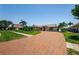 Charming home with a brick driveway, lush lawn and tropical landscaping at 671 Tallahassee Ne Dr, St Petersburg, FL 33702