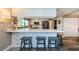 Well-lit kitchen with seating, stainless steel appliances, white cabinetry, and views out to the spacious backyard at 671 Tallahassee Ne Dr, St Petersburg, FL 33702