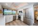 Bright kitchen with white cabinets, stainless steel appliances, quartz countertops, and a large window with outdoor views at 671 Tallahassee Ne Dr, St Petersburg, FL 33702